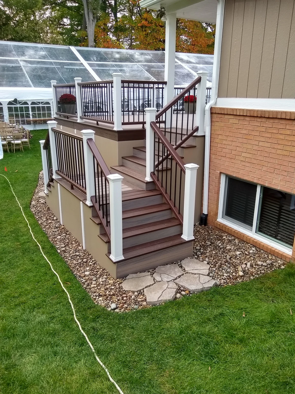 Multi-level cedar deck with railings and landscaping